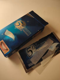 5D White Teeth Whitening Strips box with an open packet showing the whitening strips inside