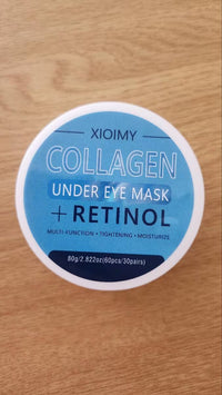 Blue Xioimy Collagen and Retinol Under Eye Mask lid label on a wooden surface.