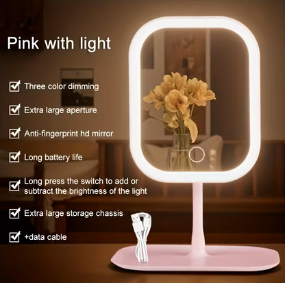 Pink LED makeup mirror with warm lighting displayed in a lifestyle setting, with feature callouts including three colour dimming, anti-fingerprint HD mirror, long battery life, and extra large storage chassis