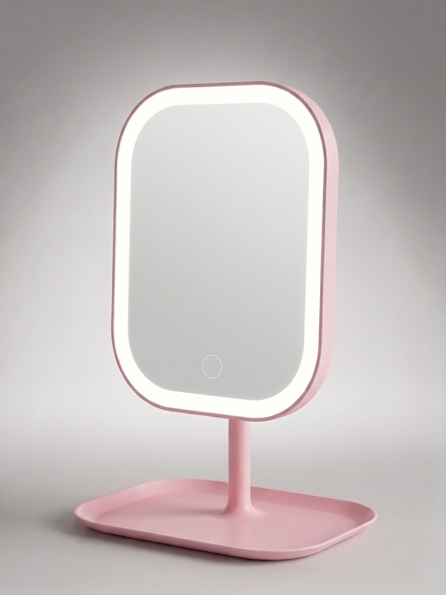 Pink LED makeup mirror with rounded rectangular frame and touch control, displayed on a storage tray base against a light grey background